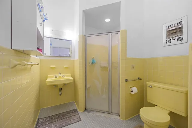 a bathroom with a toilet sink and shower