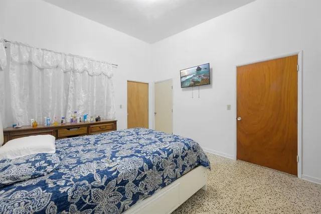 a bedroom with a bed and a dresser