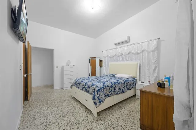 a bedroom with a bed and a dresser