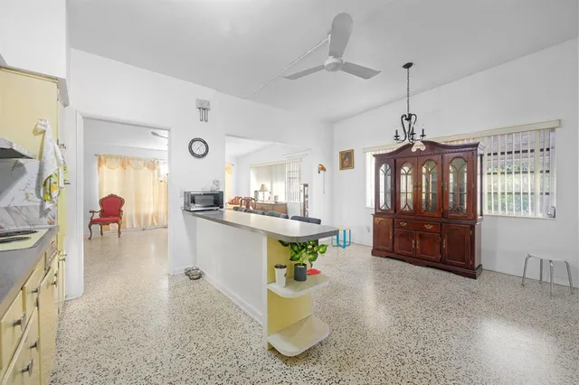 a very nice looking living room with kitchen and furniture