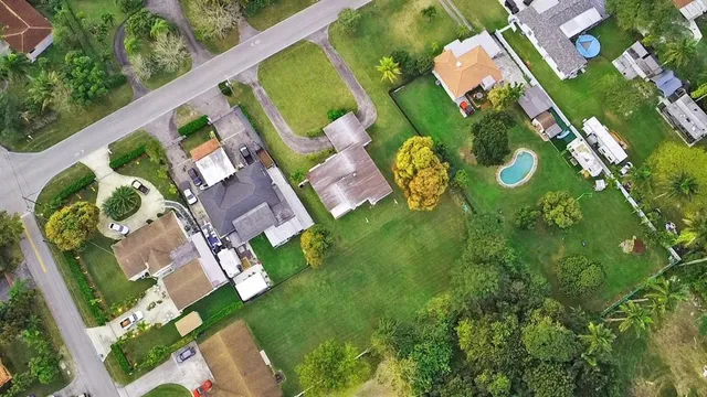 an aerial view of a house with a yard