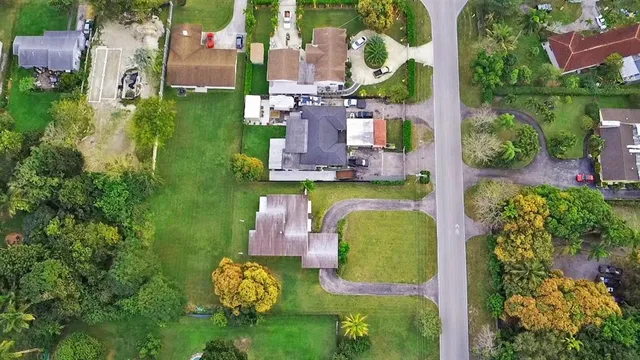an aerial view of a house with a garden and lake view