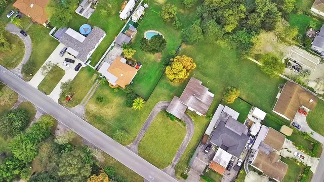 an aerial view of a residential houses with outdoor space