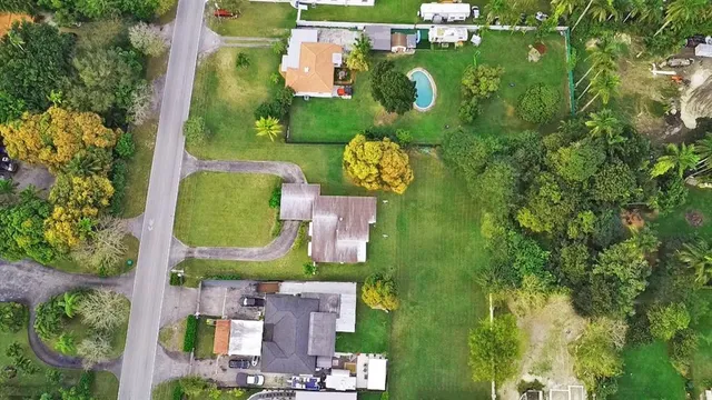 an aerial view of a houses with yard