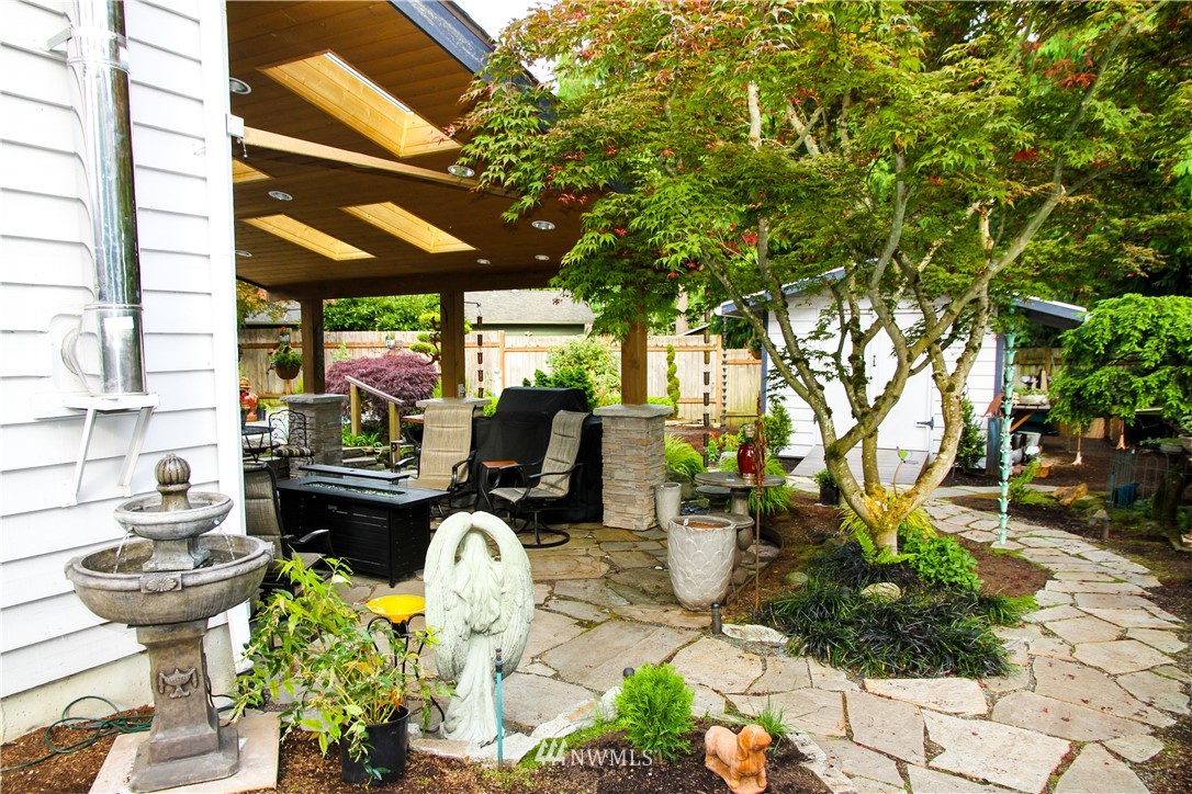 17511 26th Drive Southeast Bothell, WA 98012 - Photo 22 of 23 a view of a patio with table and chairs potted plants and large tree