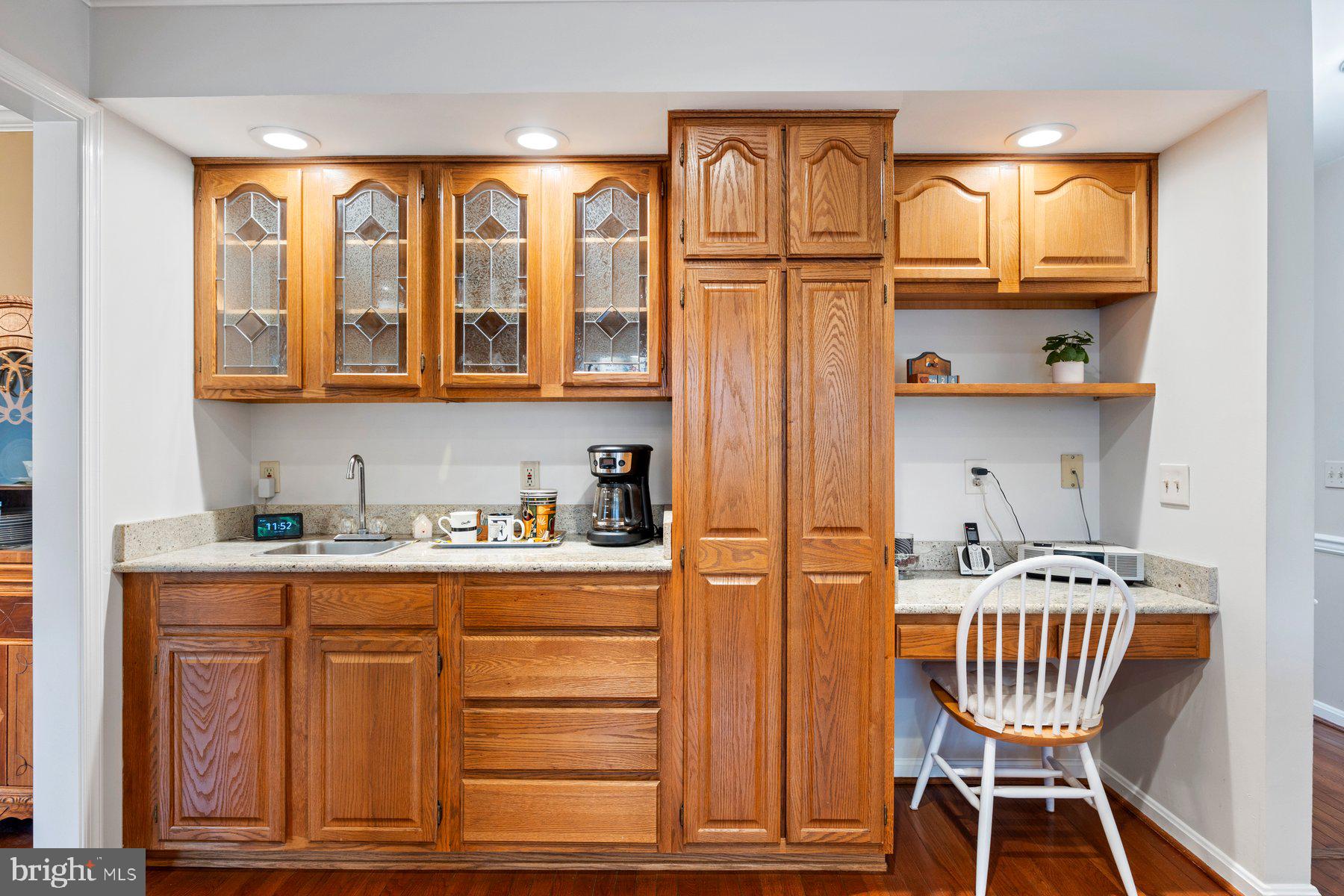 8037 Crest Road Laurel, MD 20723 - Photo 13 of 60 a kitchen with granite countertop wooden cabinets and dining table