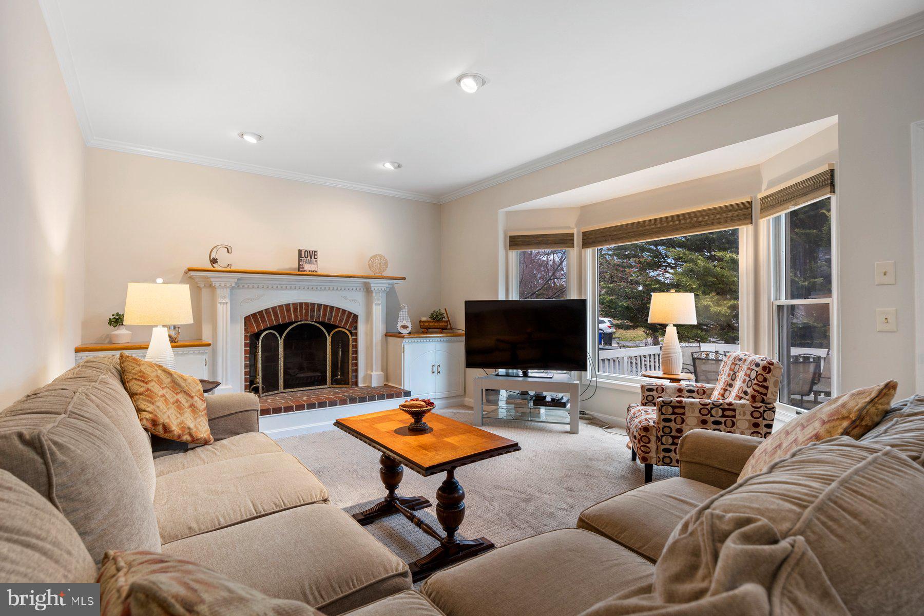 8037 Crest Road Laurel, MD 20723 - Photo 15 of 60 a living room with furniture a rug and a fireplace