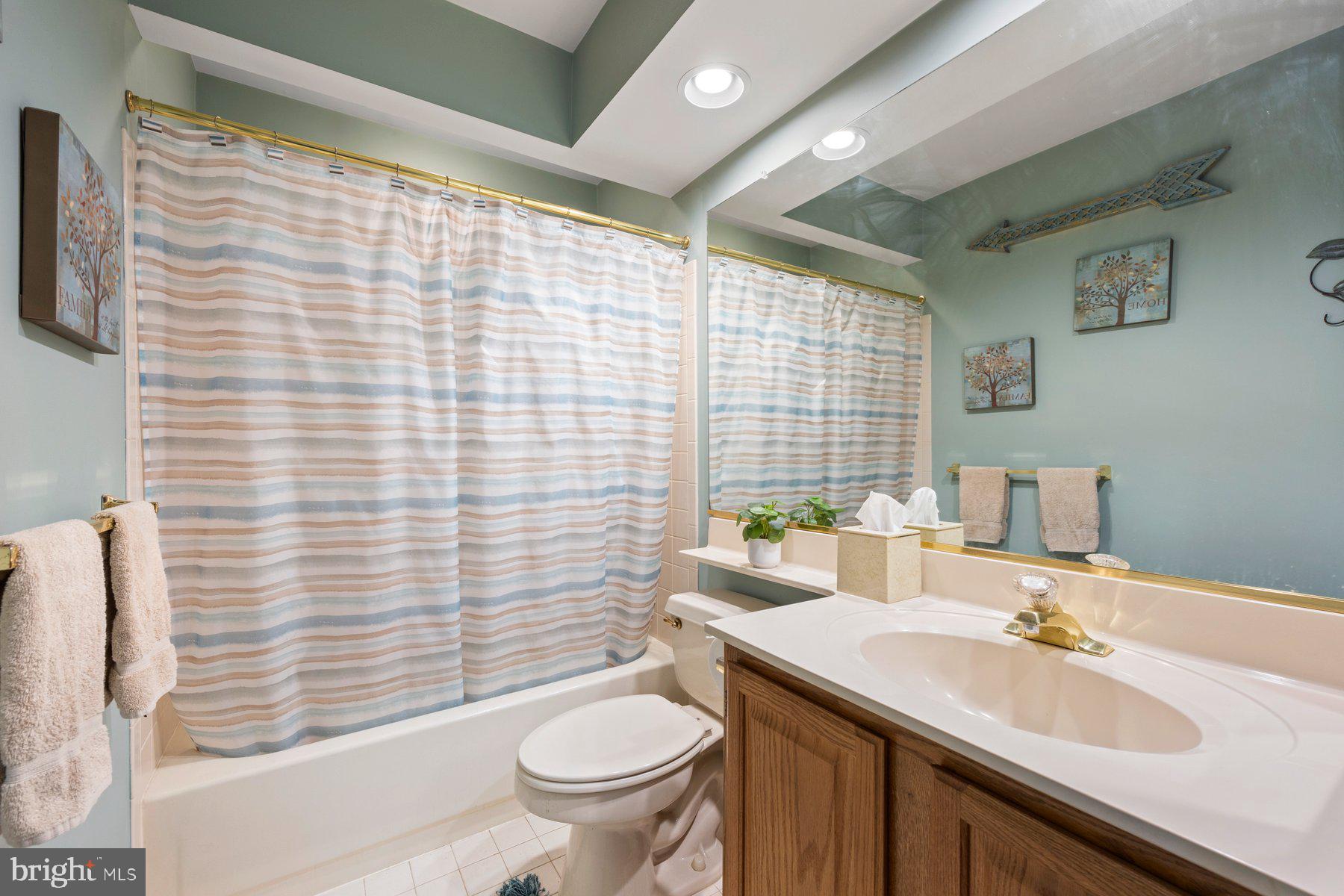 8037 Crest Road Laurel, MD 20723 - Photo 19 of 60 a bathroom with a sink toilet and shower