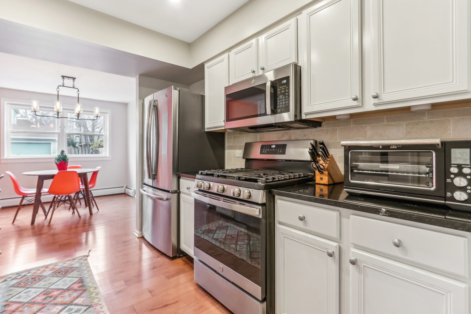 815 Reba Place, Unit 104 Evanston, IL 60202 - Photo 11 of 26 a kitchen with stainless steel appliances granite countertop a stove a refrigerator and a microwave