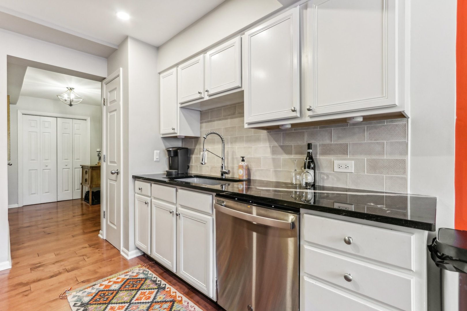 815 Reba Place, Unit 104 Evanston, IL 60202 - Photo 13 of 26 a kitchen with granite countertop white cabinets and stainless steel appliances