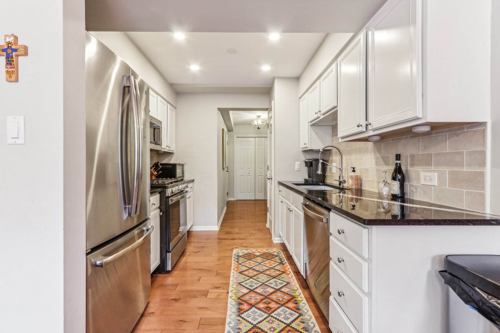 815 Reba Place, Unit 104 Evanston, IL 60202 - Photo 14 of 26 a kitchen with stainless steel appliances granite countertop a refrigerator and a sink
