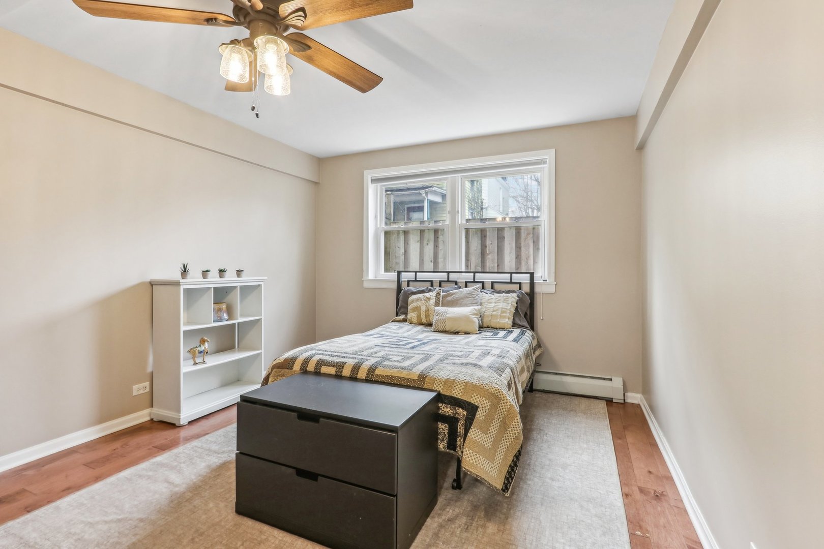 815 Reba Place, Unit 104 Evanston, IL 60202 - Photo 19 of 26 a bedroom with a bed and a chandelier