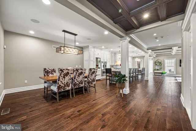 a dining room with furniture wooden floor and chandelier