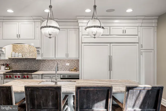 a kitchen with stainless steel appliances granite countertop a sink a stove and a refrigerator