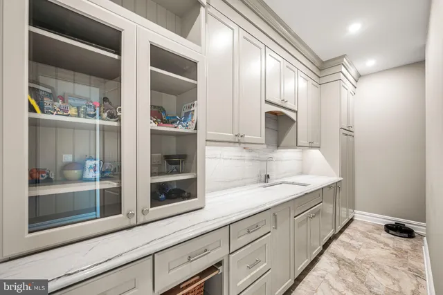 a bathroom with a granite countertop double vanity and a mirror