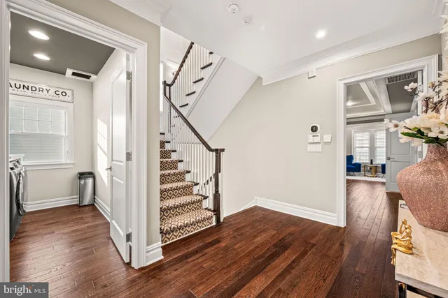 a view of entryway with wooden floor and stairs