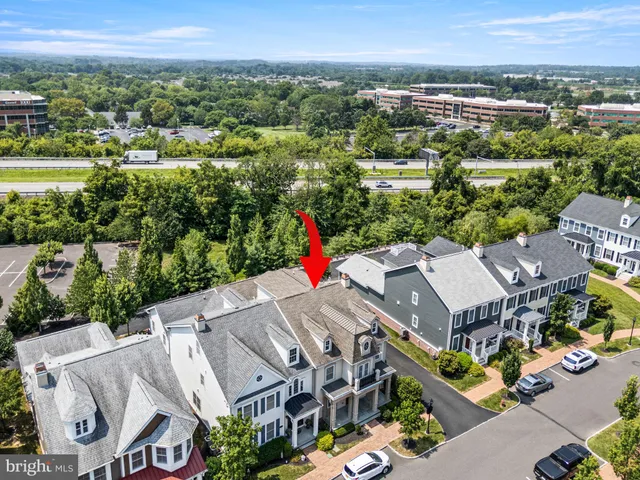 an aerial view of a city with lots of residential buildings and mountain view in back