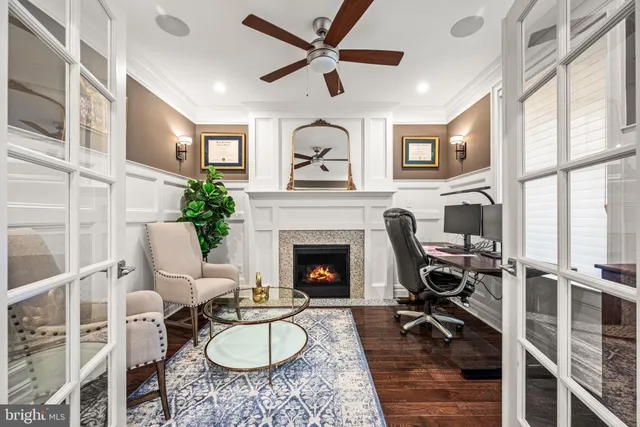 a living room with furniture a fireplace and a large window