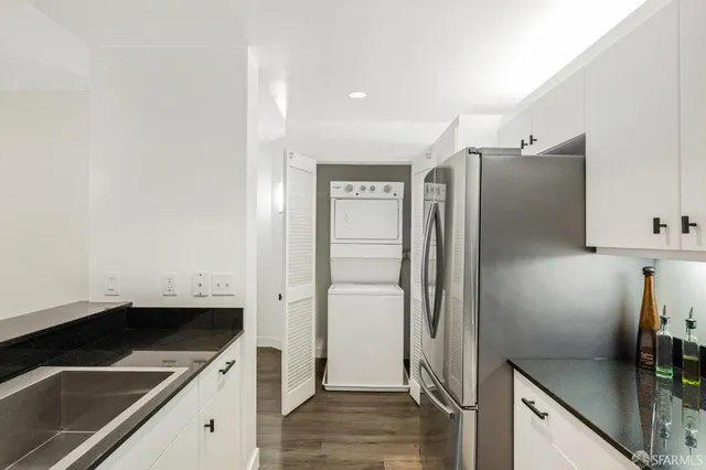 a kitchen with a refrigerator and a sink