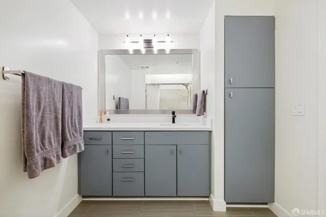a bathroom with a double vanity sink and a mirror