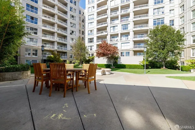 a view of a building with a dining table and chairs