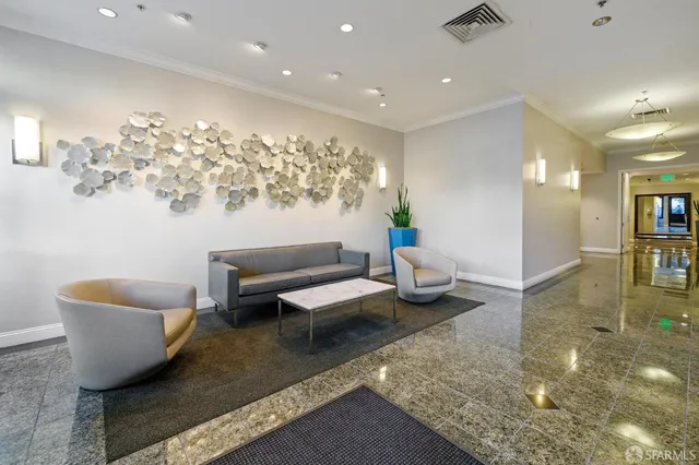 a living room with furniture and a view of kitchen