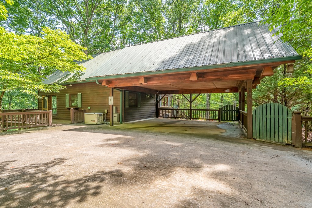 197 Smith Hill Road Blue Ridge, GA 30513 - Photo 3 of 36 a backyard of a house with large trees and wooden fence