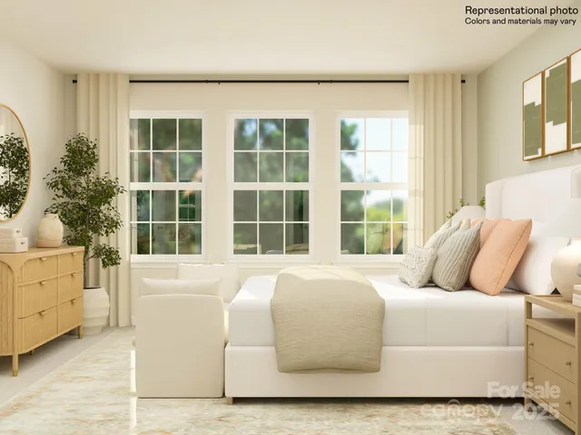 a large bed sitting in a bedroom next to a window