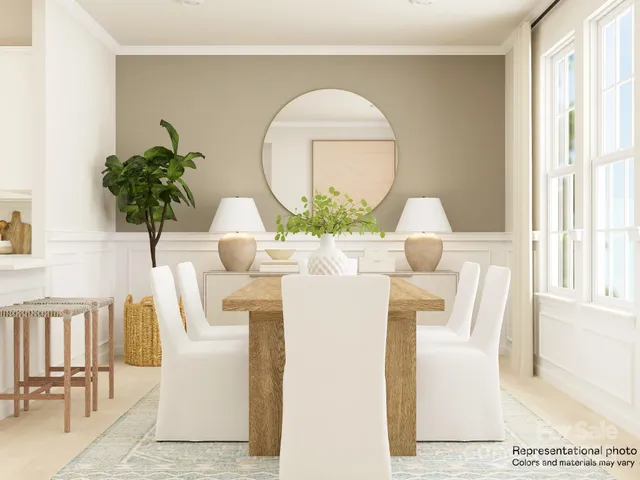 a living room with furniture a potted plant and a large window