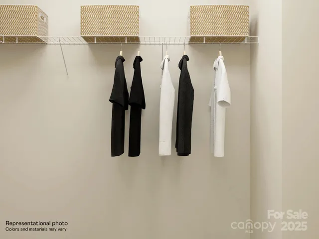 a view of walk in closet with clothes