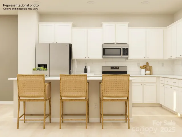 a kitchen with table and chairs