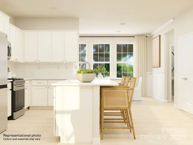 a kitchen with a sink cabinets and window