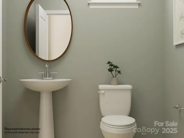 a bathroom with a toilet a sink and a mirror