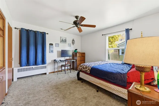 a bedroom with a bed and a chandelier