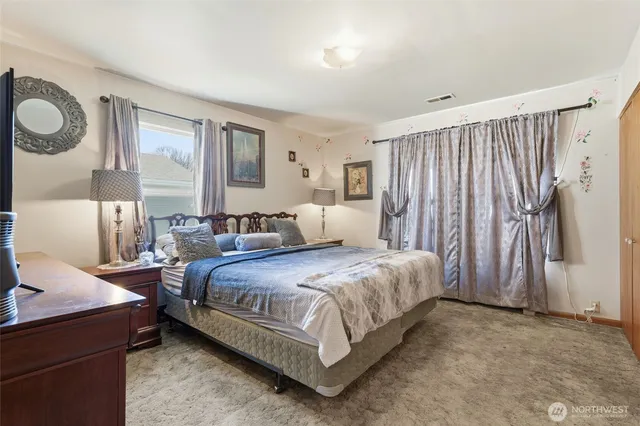 a spacious bedroom with a bed and window