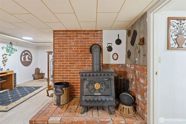 a view of a hallway with wooden floor and a bathroom