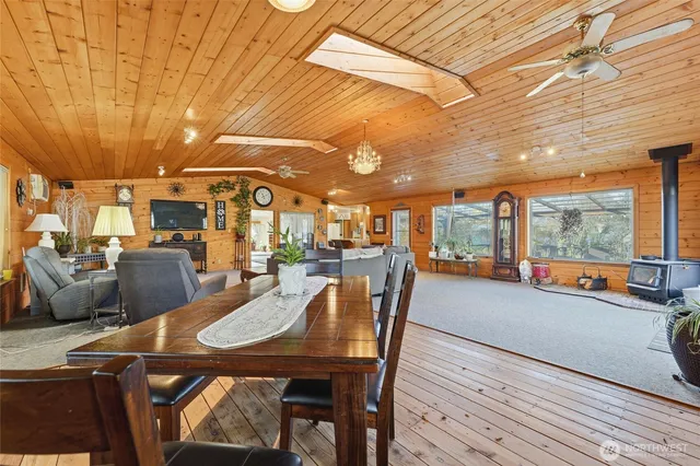 a dining room with furniture and a floor to ceiling window