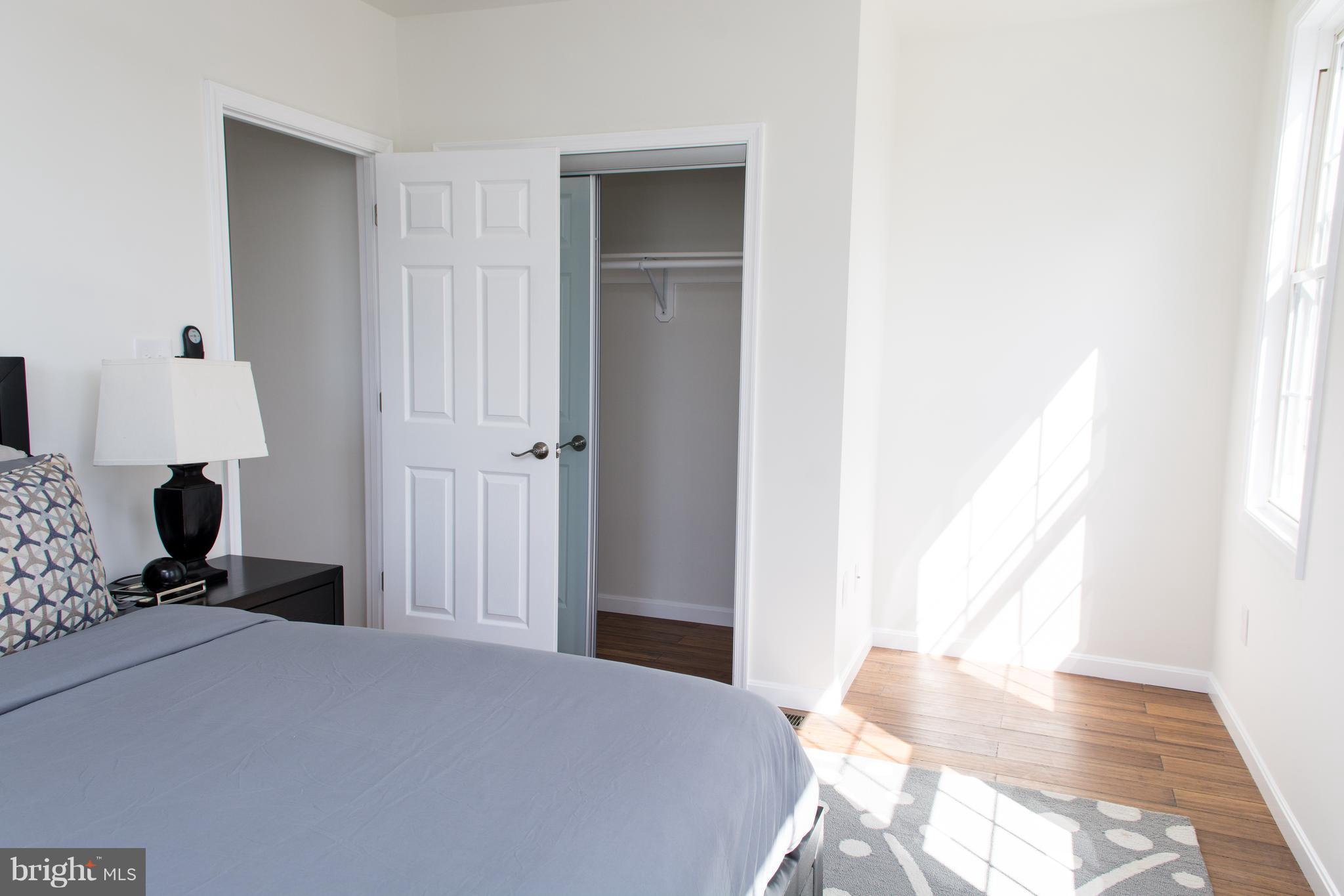 6216 5th Street Northwest Washington, DC 20011 - Photo 15 of 25 a bedroom with a bed and wooden floor