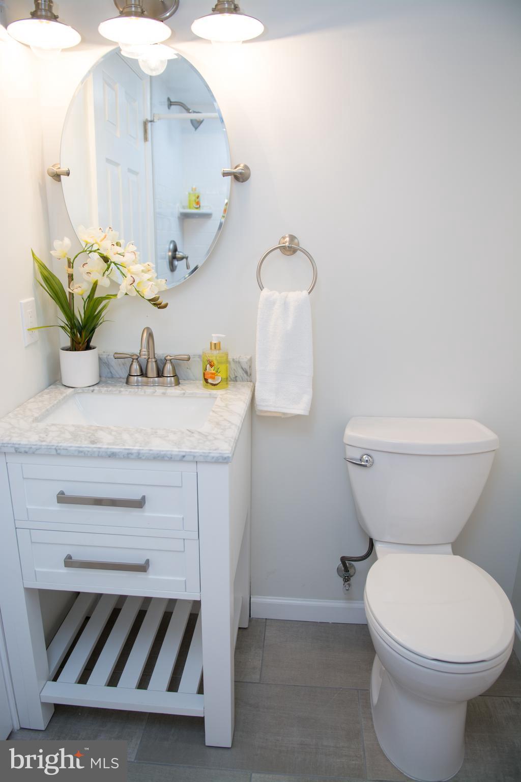 6216 5th Street Northwest Washington, DC 20011 - Photo 19 of 25 a bathroom with a toilet sink and mirror