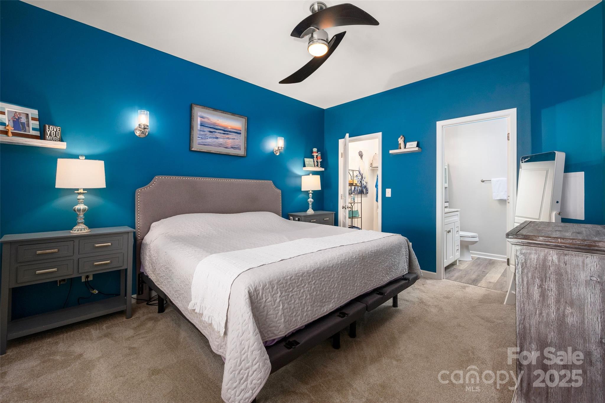 969 Copperstone Lane Fort Mill, SC 29708 - Photo 18 of 36 a bedroom with a bed and a chandelier