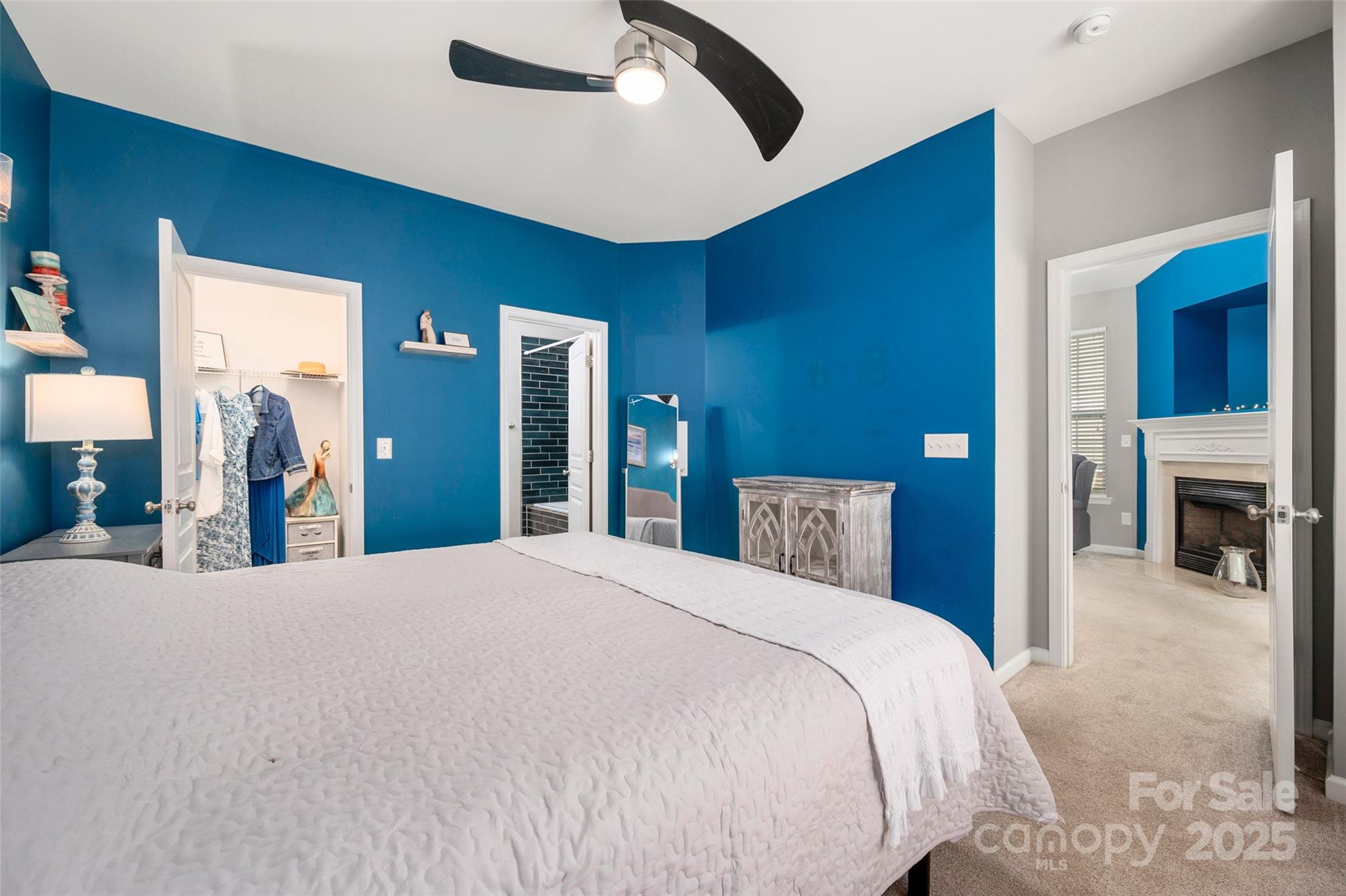 969 Copperstone Lane Fort Mill, SC 29708 - Photo 19 of 36 a bedroom with a large bed and a chandelier