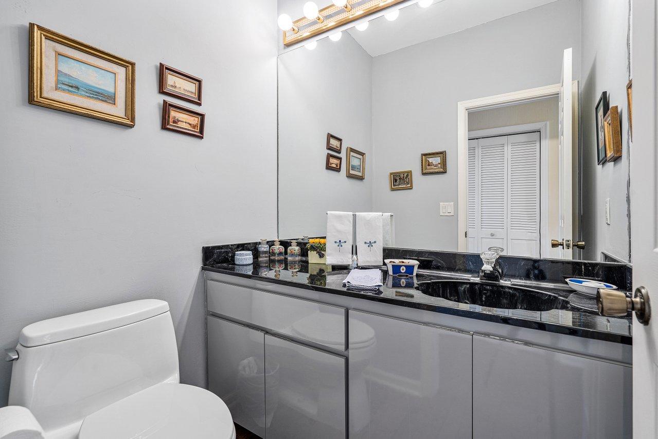 169 Apollo Circle Jupiter, FL 33477 - Photo 17 of 54 a bathroom with a granite countertop sink mirror and toilet