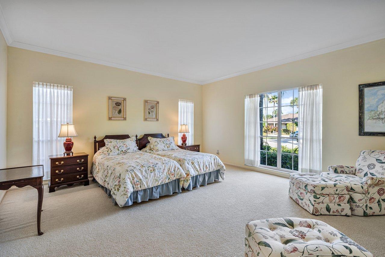 169 Apollo Circle Jupiter, FL 33477 - Photo 18 of 54 a spacious bedroom with a bed and a couch