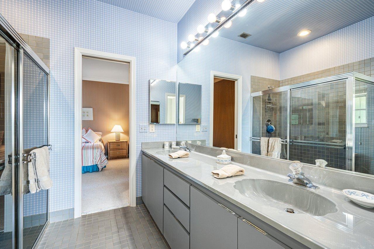 169 Apollo Circle Jupiter, FL 33477 - Photo 23 of 54 a en suite bathroom with a double vanity sink and a mirror