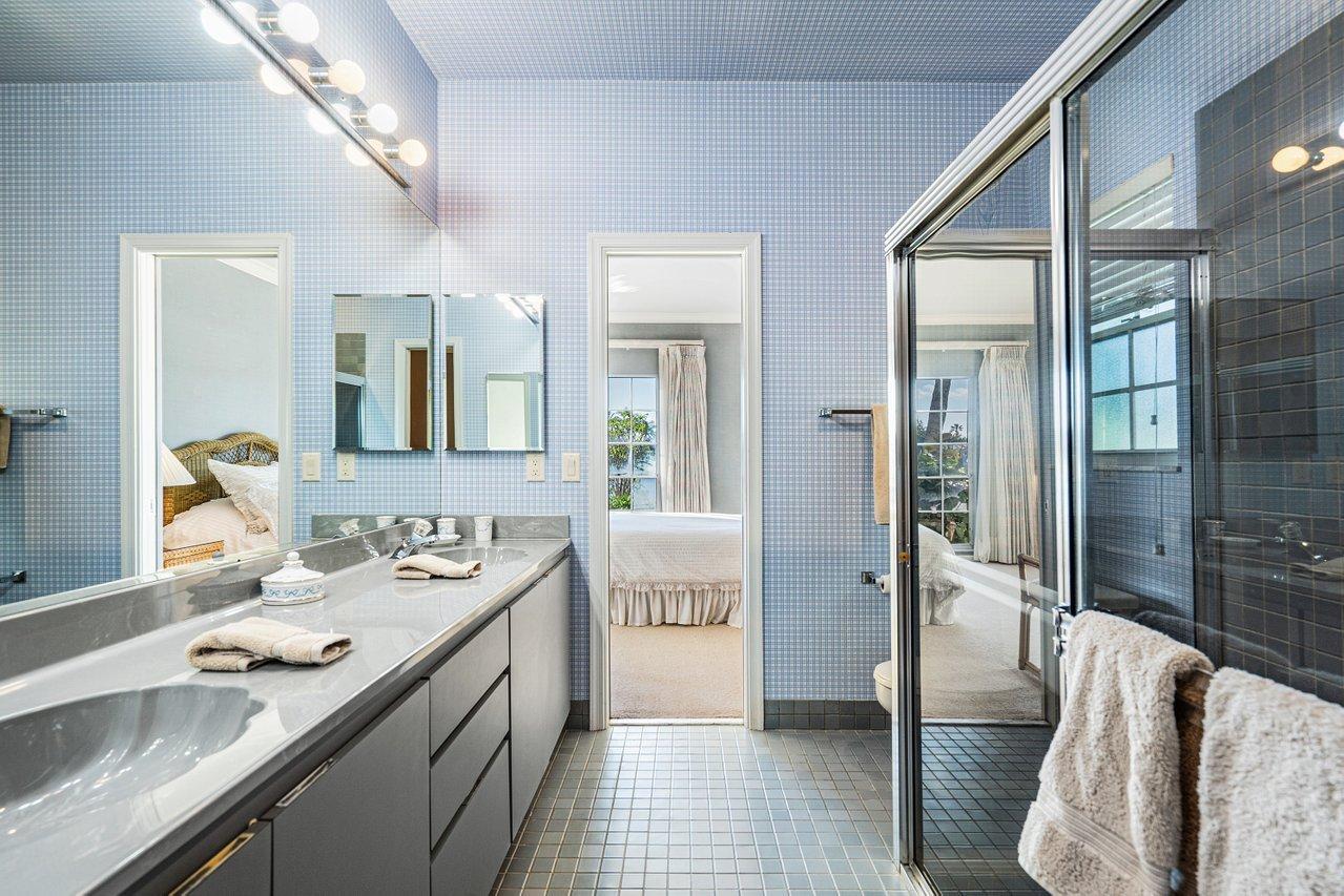 169 Apollo Circle Jupiter, FL 33477 - Photo 24 of 54 a spacious bathroom with a double vanity sink a mirror and a shower