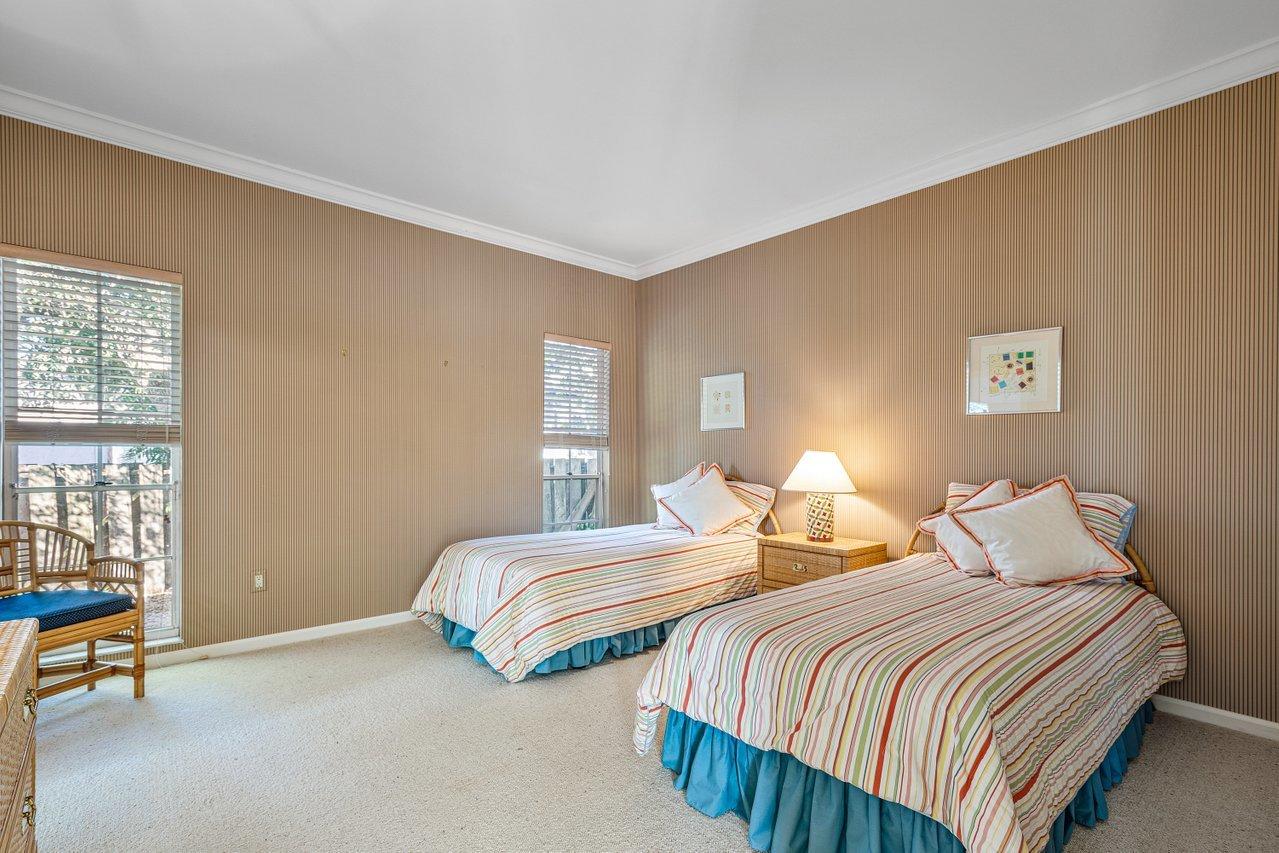 169 Apollo Circle Jupiter, FL 33477 - Photo 25 of 54 a bedroom with two beds and a lamp next to a window