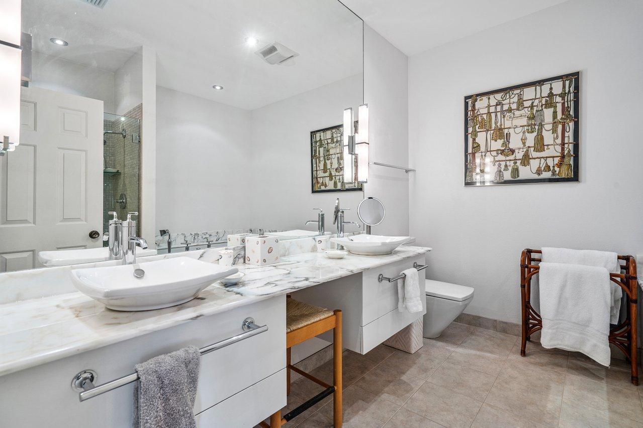 169 Apollo Circle Jupiter, FL 33477 - Photo 30 of 54 a bathroom with a double vanity sink and a mirror