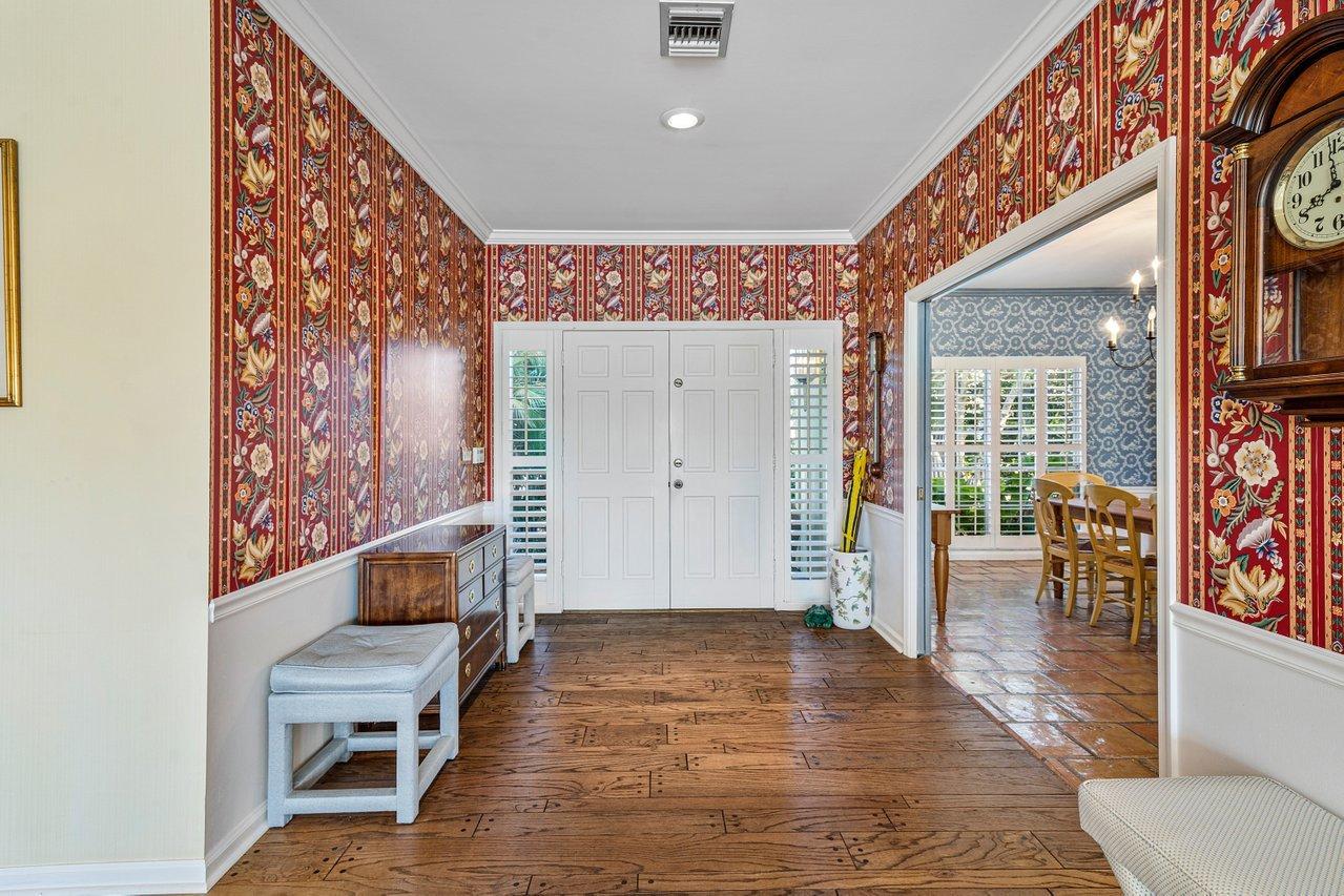 169 Apollo Circle Jupiter, FL 33477 - Photo 4 of 54 a view of a hallway with wooden floor and furniture