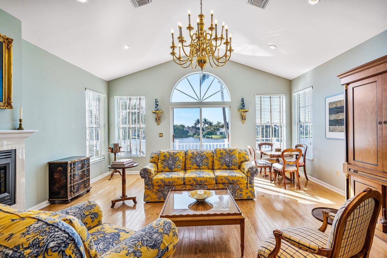 169 Apollo Circle Jupiter, FL 33477 - Photo 32 of 54 a living room with furniture a fireplace and a chandelier
