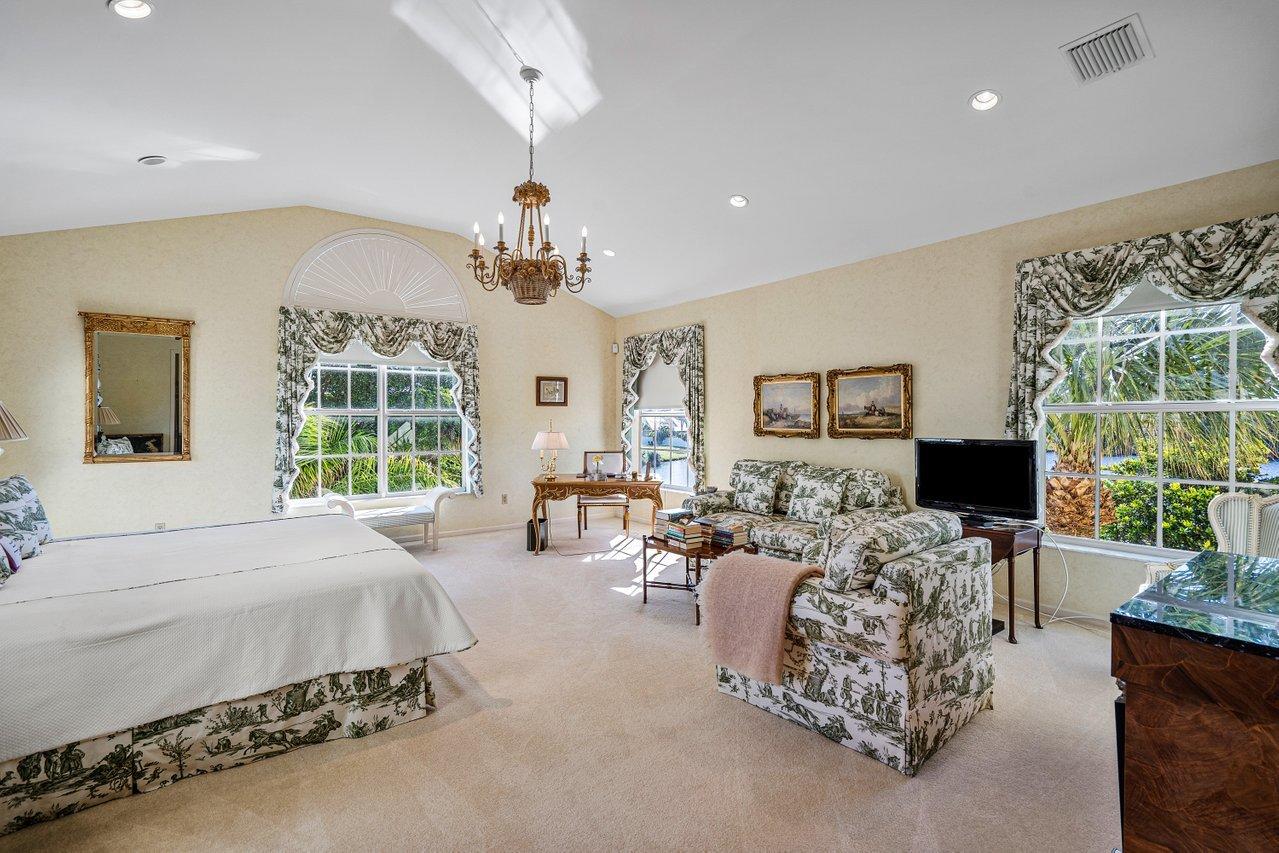 169 Apollo Circle Jupiter, FL 33477 - Photo 37 of 54 a bedroom with furniture a flat screen tv and a large window